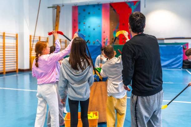 istock Students and teacher playing floorball in school gym 2199328239