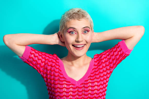 istock Stylish young woman with a cheerful expression against a turquoise background in vibrant fashion 2199328372