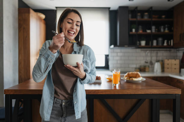 istock Young Woman Enjoying a Healthy Breakfast in a Modern Kitchen 2199329616