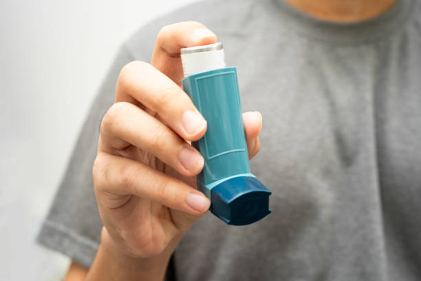 istock Asthma and chronic obstructive pulmonary disease COPD, Asian young man using metered dose inhaler MDI. 2199332525