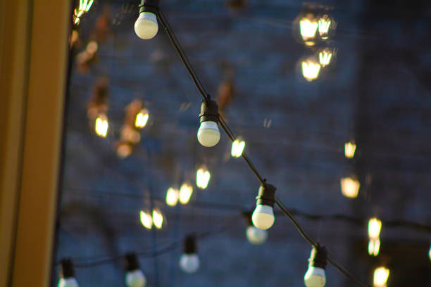 istock Industrial pendant lamps against rough wall. Loft interior. Edison bulbs. 2199332877
