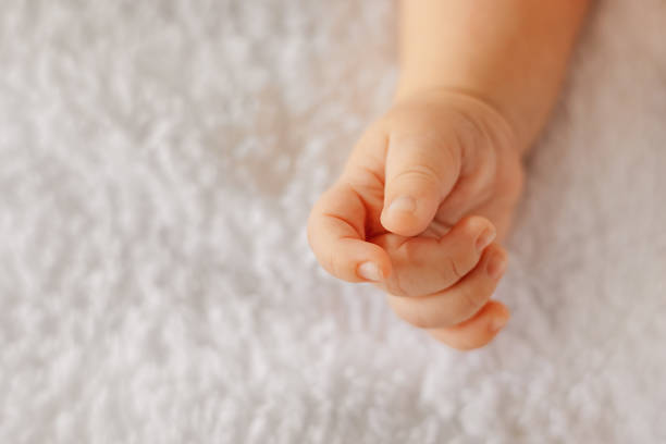 The hand of a newborn on a light background