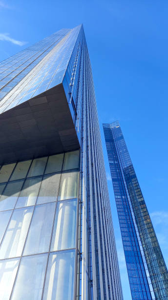 istock High-rise skyscraper urban office building taken from low angle against blue sky 2199334936