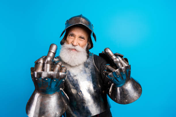 istock Bearded senior man in armor displaying confidence against a blue background 2199337362