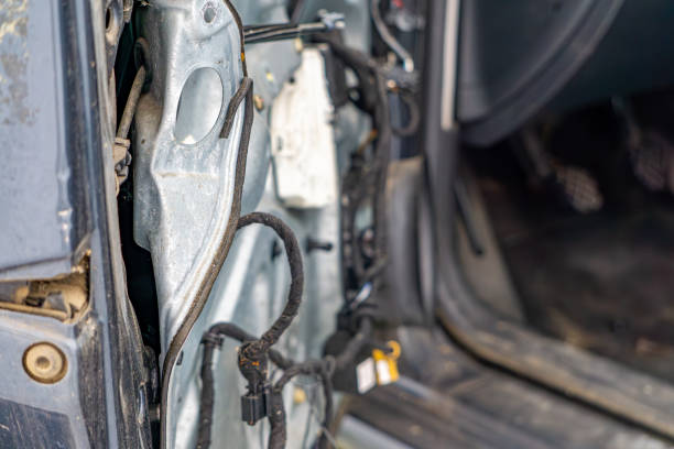 istock passenger car after collision, missing driver's door panel. bent metal in doors and broken electrical wiring harnesses. 2199337985
