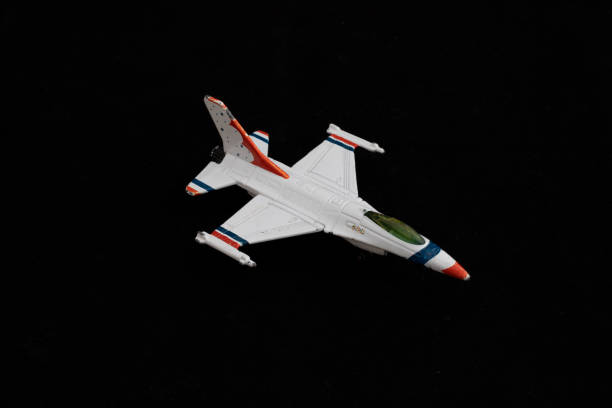 White Fighter Jet Toy with Red and Blue Accents on Black Background