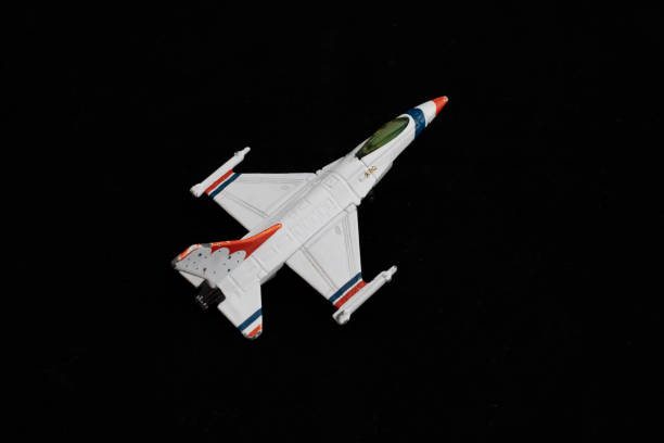 istock White Fighter Jet Toy with Red and Blue Accents on Black Background 2199339737