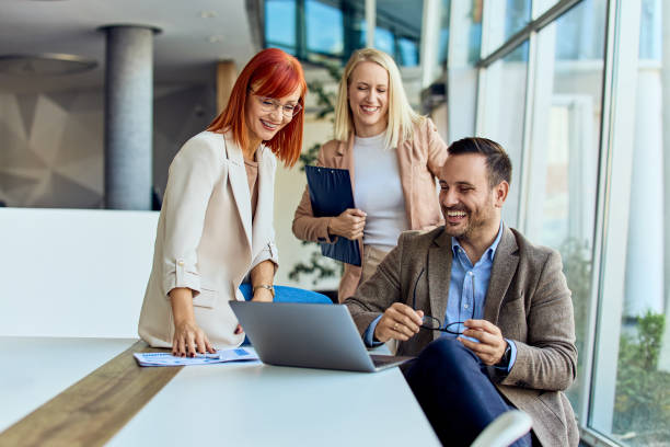 istock Group of Professionals Collaborating in a Modern Office Environment 2199340130