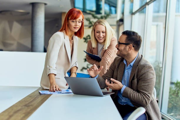 istock Business Team Collaborating at Modern Office with Laptop and Documents 2199340132