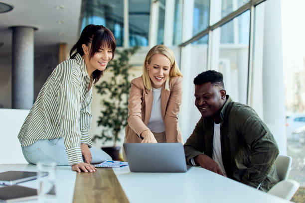 istock Diverse Team Collaborating Around Laptop in Modern Bright Office Environment 2199340138