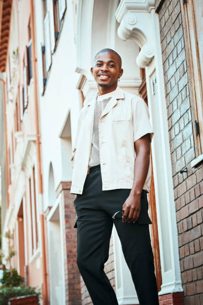 istock Stylish Young Man Smiling Outdoors in Urban Setting Against Architectural Backdrop 2199341664