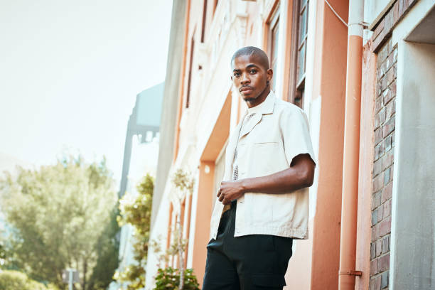 istock Confident Man Posing Casually Outdoors on a Sunny Day in Urban Street Setting 2199341682