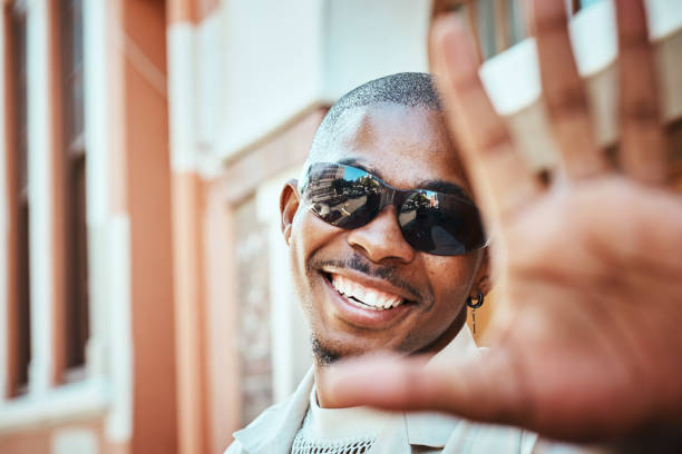 istock Positive Young Man Wearing Sunglasses Smiling Outdoors During a Sunny Day 2199341684