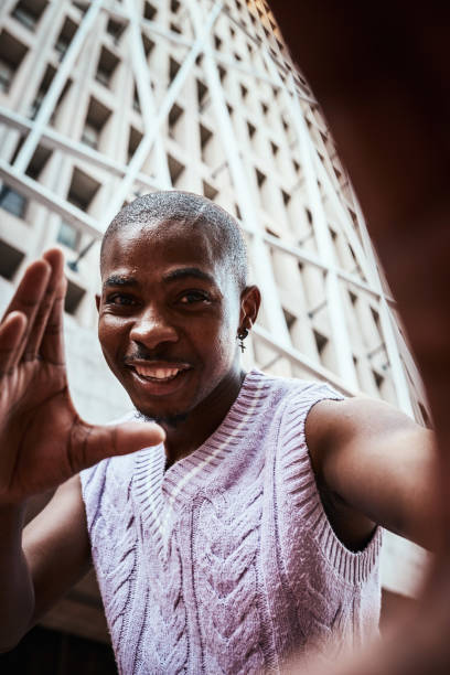 istock Smiling Man Taking a Self-Portrait Against an Urban Architectural Backdrop 2199341758