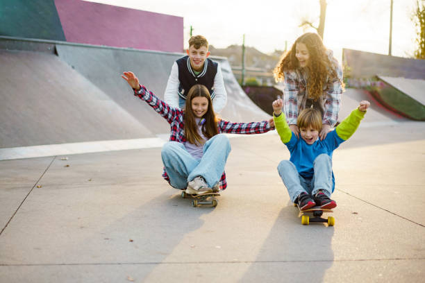 istock Children have fun skateboarding in the park 2199342830