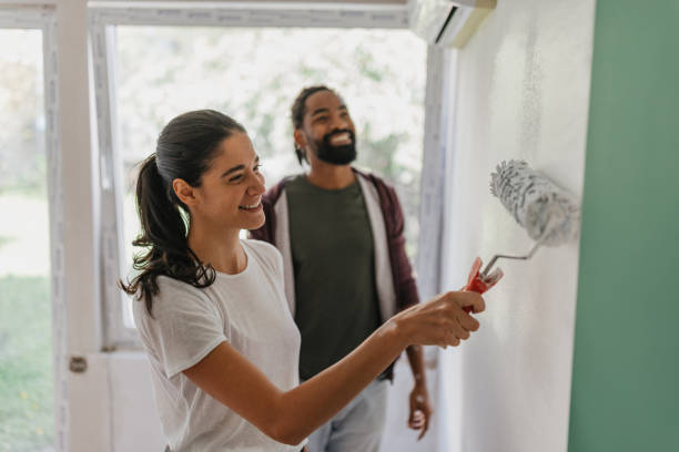 istock Woman Laughing While Painting a Room with Partner 2199343917