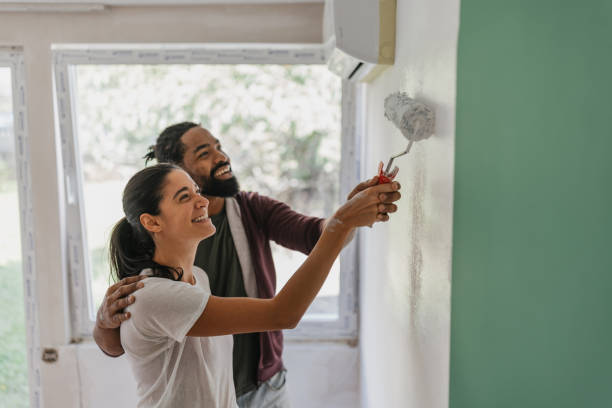 istock Couple Having Fun Painting a Wall Together 2199344006