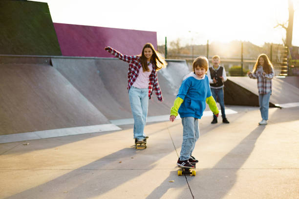 istock A boy and a girl skate in the park 2199344462
