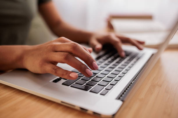 istock Young woman using a laptop for online banking at home 2199347200