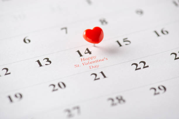 istock A small red heart-shaped pin marking Valentine's Day on a calendar page, symbolizing love 2199347764