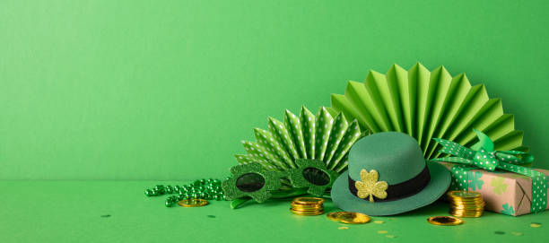 istock Festive setup featuring green decorations, a leprechaun's hat, shamrocks, gold coins, and wrapped gifts, symbolizing St. Patrick's Day celebration and Irish festivities 2199347768