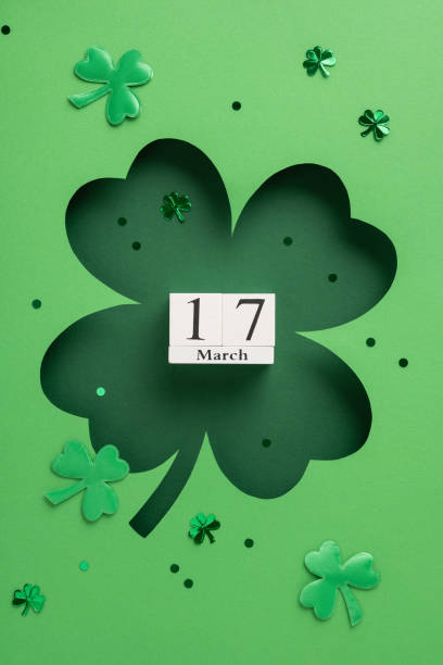 istock A vertical creative green background with shamrock cutouts highlighting March 17 for Saint Patrick's Day 2199347773