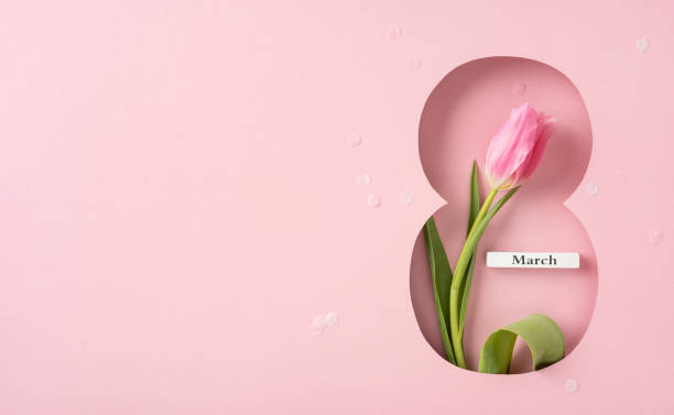 istock A vibrant pink tulip placed within a figure eight design on a pink background. Perfect for representing Women's Day celebrations and floral aesthetics. 2199347782