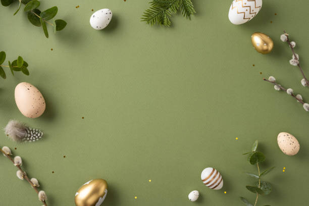 istock Festive arrangement featuring Easter eggs, leaves, and ornaments positioned against a green backdrop celebrating the season of spring and Easter 2199347800