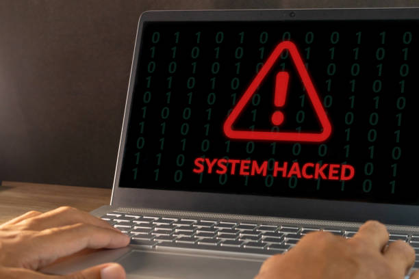 istock Warning of a system hacked concept. Hacker or cyber criminal with laptop stealing user personal data. 2199349261
