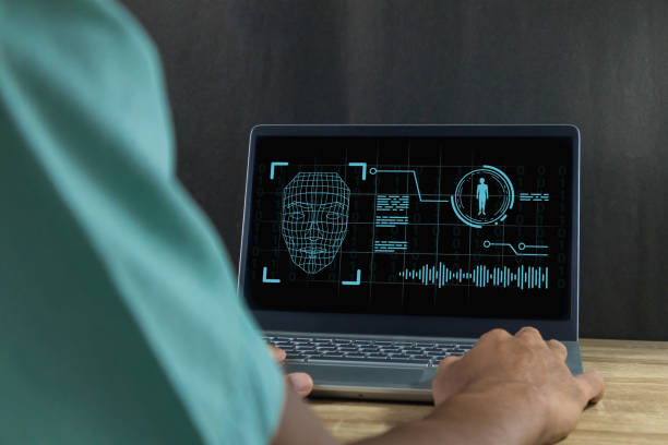 istock Deepfake and artificial intelligence concept. Man using a laptop to create convincing fake image, video and audio recording. 2199349287