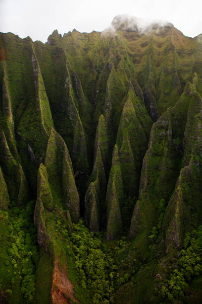 istock Napali Coast Massive Rippled Mountains in Intense Shadows from Helicopter View in Kauai Hawaii 2199349700