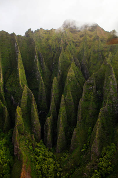 istock Napali Coast Massive Rippled Mountains in Intense Shadows from Helicopter View in Kauai Hawaii 2199349734