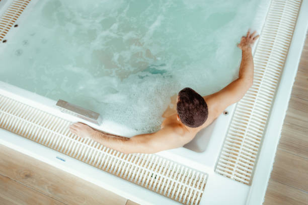 istock Solo Relaxation: Man Unwinding in a Hotel hot tub 2199350947
