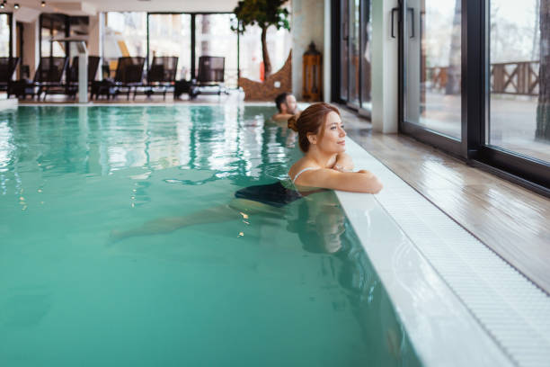 istock Peaceful Spa Retreat: Couple Relaxing in a Luxury Indoor Pool 2199350952
