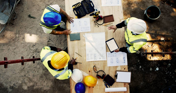 istock Construction site, business people and planning with tablet for architecture, building and blueprint. Above, engineer team and employees with ideas for industry renovation, infrastructure and meeting 2199350995
