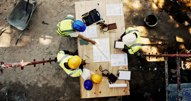 istock Construction site, business people and blueprint with tablet for architecture, building and planning. Above, engineer team and employees with ideas for industry renovation, infrastructure and meeting 2199350996