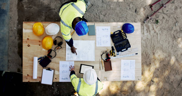 istock Construction site, tablet and business people with blueprint for architecture, building and planning. Above, engineer team and employees with ideas for industry renovation, infrastructure and meeting 2199351000