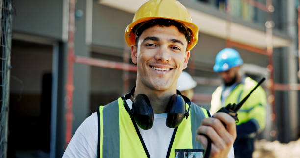 istock Construction site, engineering and man with radio, portrait and building development. Employees, architecture and coworkers for renovation, conversation and safety with helmet and communication 2199351044