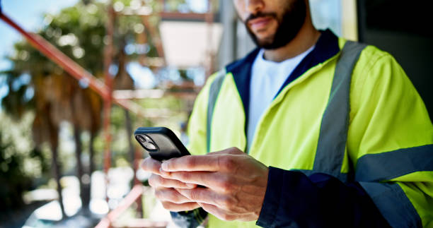 istock Hands, smartphone and construction site with texting, person or contact with info for building development. Engineer, phone and check with network, architecture and reading on mobile app at property 2199351071