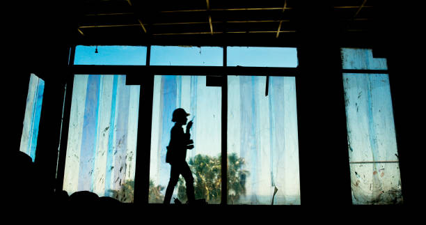 istock Silhouette, person and radio with construction site, productivity and building development project. Employee, shadow and architecture with career ambition, engineering and renovation with occupation 2199351074