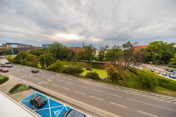 Wroclaw, Poland - July 26 2024: Modern Urban Infrastructure with Disabled Parking Space and Multi-Lane Road in Wroclaw, Poland - Aerial City View with Dramatic Sky