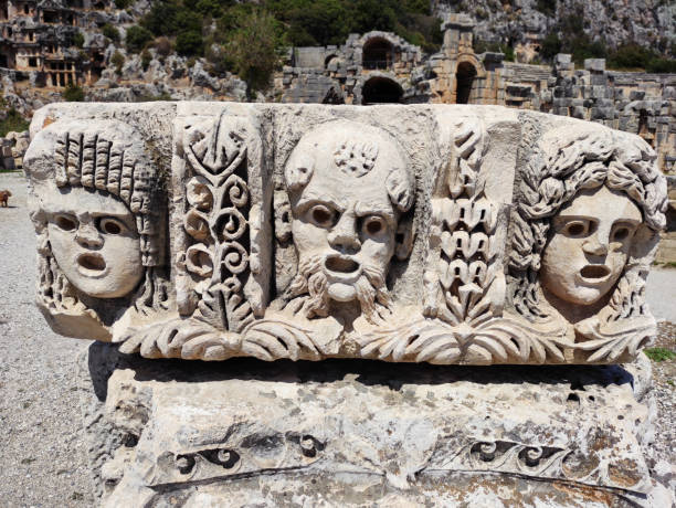 istock An ancient stone bas-relief depicting human faces, geometric and floral patterns, a fragment of an ancient Greek or Roman structure 2199353846
