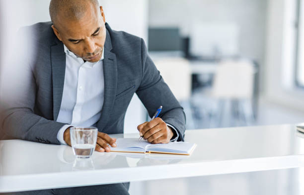 istock African American entrepreneur taking notes in the office. 2199354971