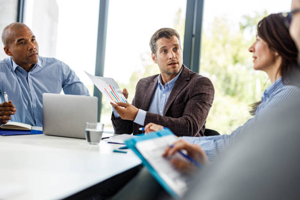 istock Business colleagues talking about reports on a meeting in the office. 2199355101
