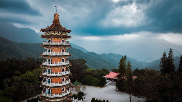 istock Pagoda stands amidst Taiwan mountains under an overcast sky with greenery in the foreground 2199355236