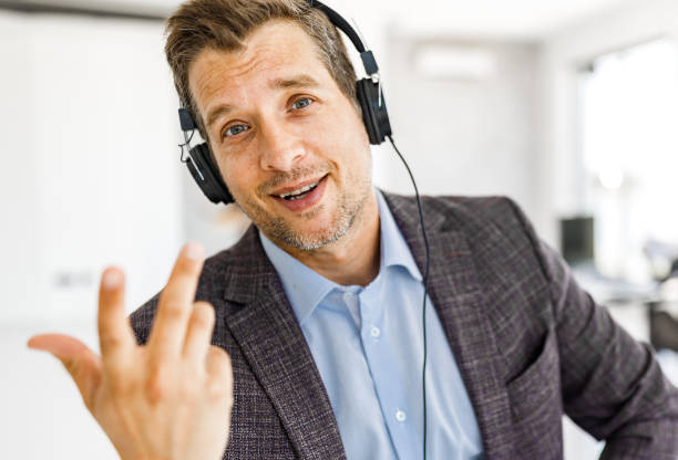 istock Happy businessman having a conference call in the office. 2199355260