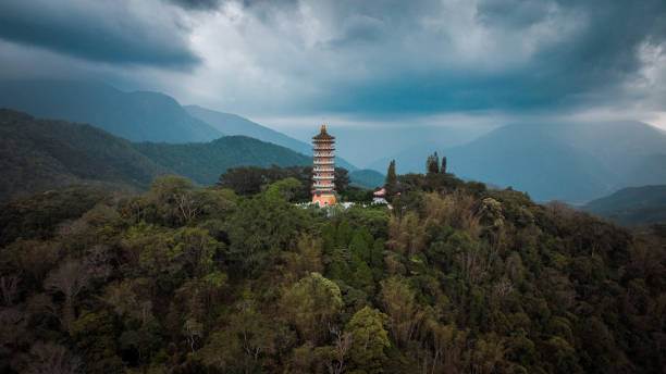 istock A tranquil view of a pagoda surrounded by lush mountains in Taiwan under dramatic clouds 2199355264