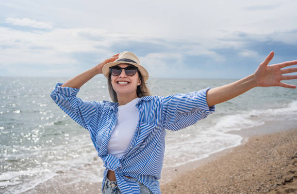 istock Happy woman on the beach 2199358844