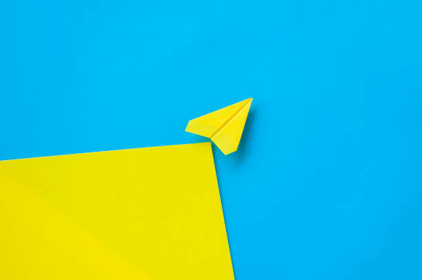 istock Top view of yellow paper airplane with customizable space for text 2199360281