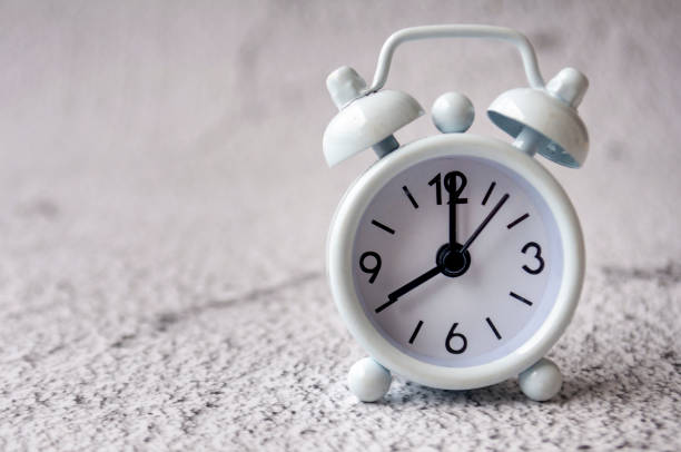 Table alarm close point at 8 am with space for text. Timer and copy space concept.